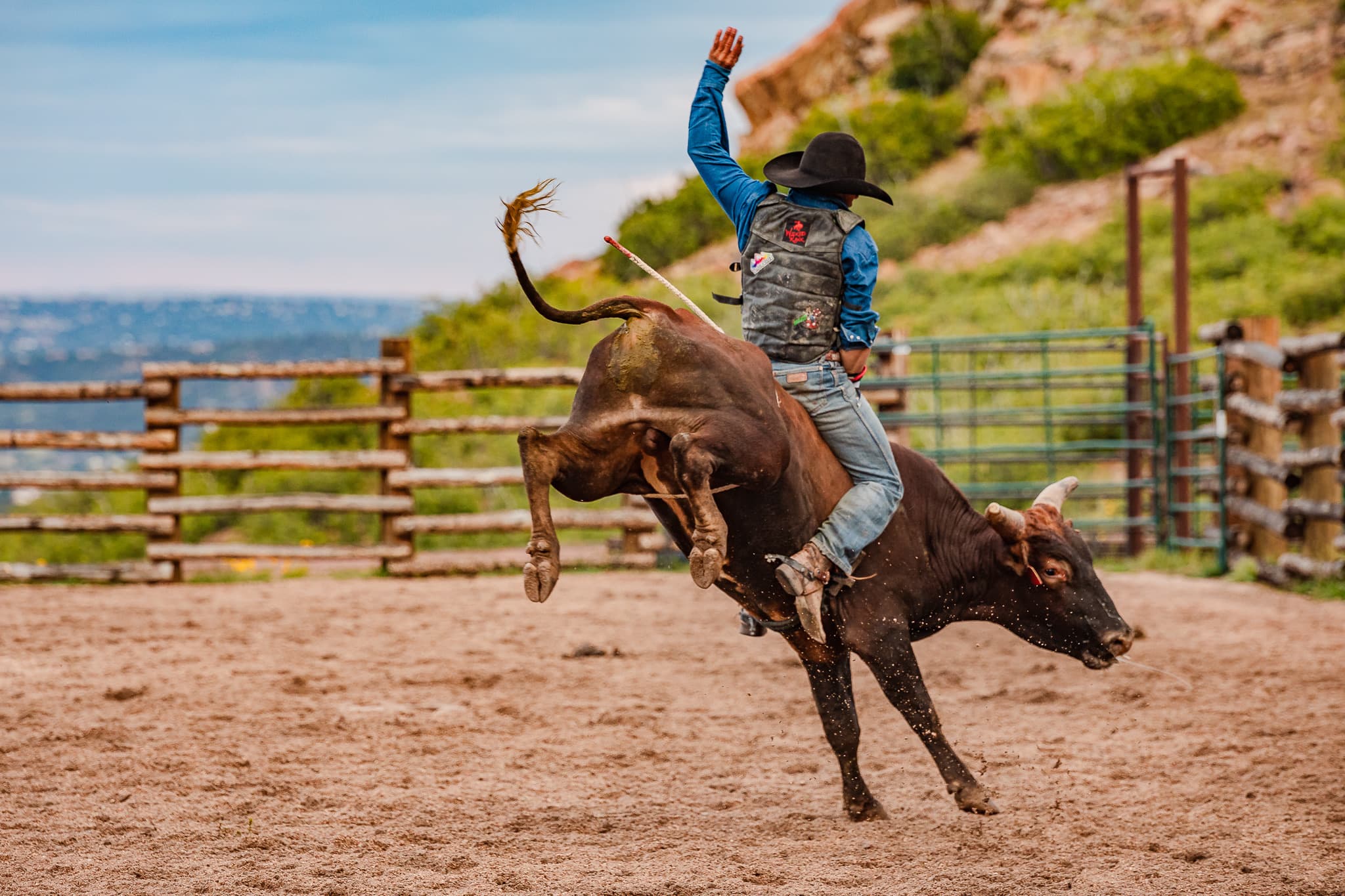 Western rodeo bull-riding action in the arena at Flying W Ranch in Colorado Springs, Colorado