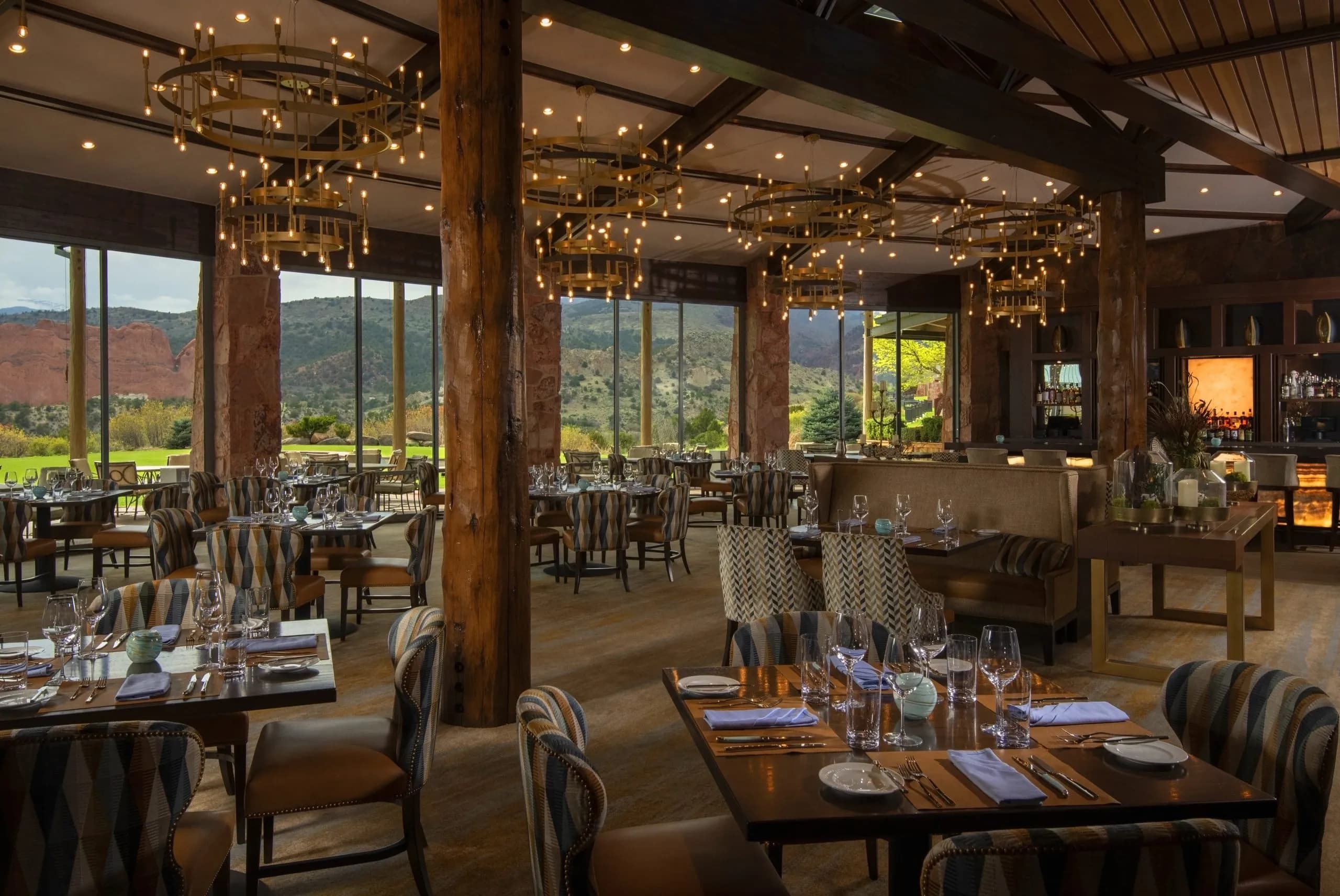 Grand View dining room with floor-to-ceiling windows overlooking red rocks at Garden of the Gods Resort in Colorado Springs