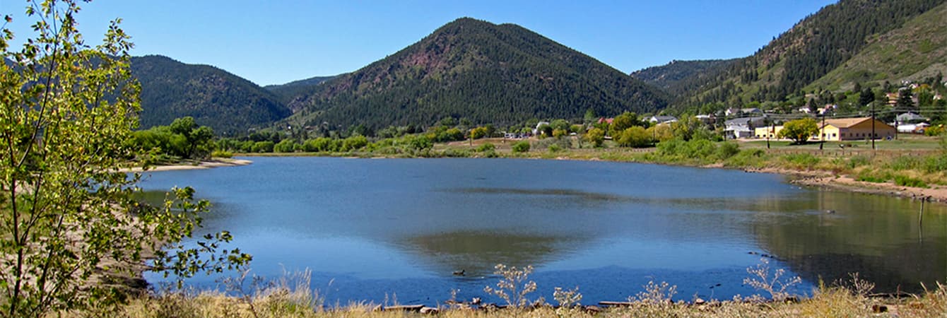 Palmer Lake reflecting Ben Lomond Mountain on a clear day at the Palmer Lake Recreation Area in Palmer Lake, Colorado