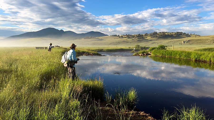 Fly fishing on a tranquil mountain stream on the grounds of The Broadmoor in Colorado Springs, Colorado